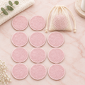 12pcs bamboo reusable makeup remover pads with mesh bag on blush marble surface